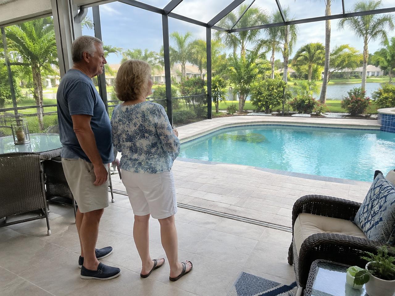 Illustrative photo of a retired couple looking out from a screened pool lanai